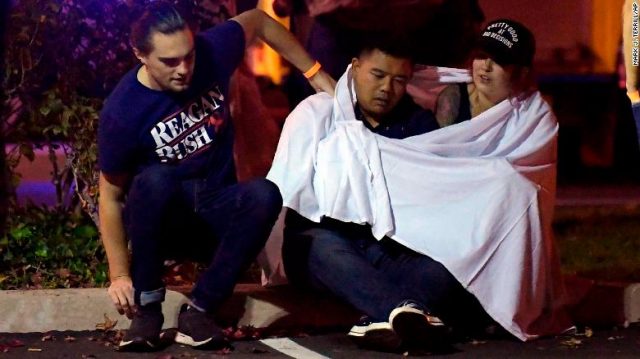 People comfort each near the scene Thursday in Thousand Oaks. 