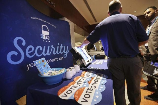 An Election Systems & Software employee demonstrated security equipment at a National Association of Secretaries of States convention in Philadelphia in July.