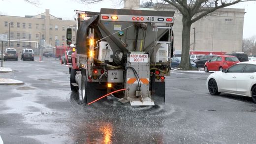 A Monmouth County road department truck spreads salt in the parking lot outside State Superior Court in Freehold Tuesday, February 12, 2019.