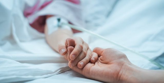 mom holding child hand hospital