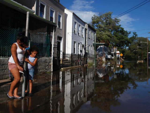 Children look as floodwaters rise from the Passaic River in Paterson, New Jersey September 9, 2011.