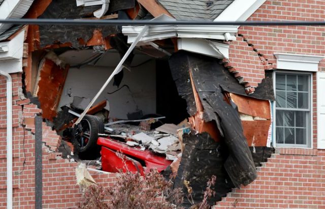 A red Porsche crashed Sunday morning into the second story of a commercial building in Toms River, killing two people, police said.