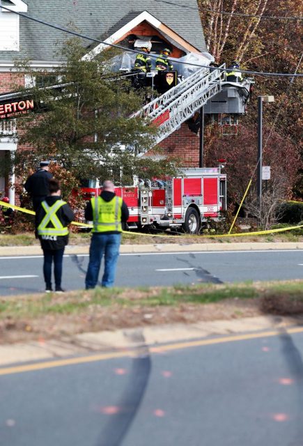 A red Porsche crashed Sunday morning into the second story of a commercial building in Toms River, killing two people, police said.