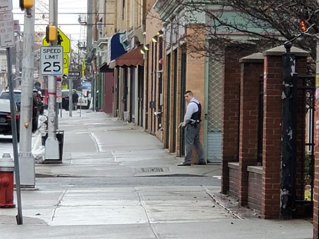 A Jersey City police officer draws his weapon while responding to an active shooter incident on Martin Luther King Drive and Bidwell Avenue on Tuesday, Dec. 10, 2019. (Josh Rosario | The Jersey Journal)
