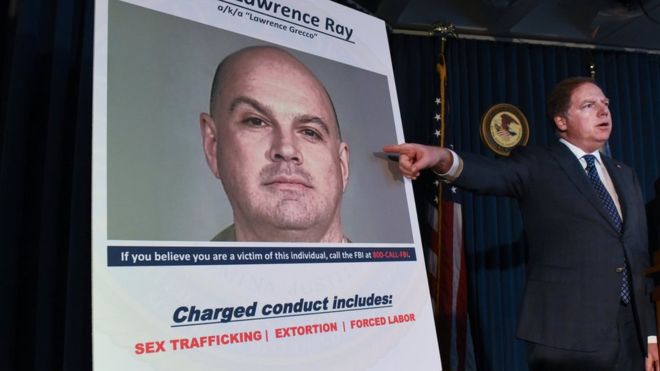 Manhattan US Attorney Geoffrey Berman points at a photo of Lawrence Ray as charges are announced in New York City in February 2020.