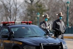 Police officers wear protective masks at the checkpoint of a testing facility for the novel coronavirus in New Rochelle, N.Y., on Monday. (Andrew Kelly/Reuters)