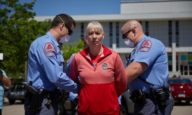 A protester from a grassroots organization called ReopenNC is arrested after refusing to leave a parking lot during a demonstration against the North Carolina CCP virus lockdown at the North Carolina State Legislature in Raleigh, North Carolina, on April 14, 2020. (Logan Cyrus/AFP via Getty Images)